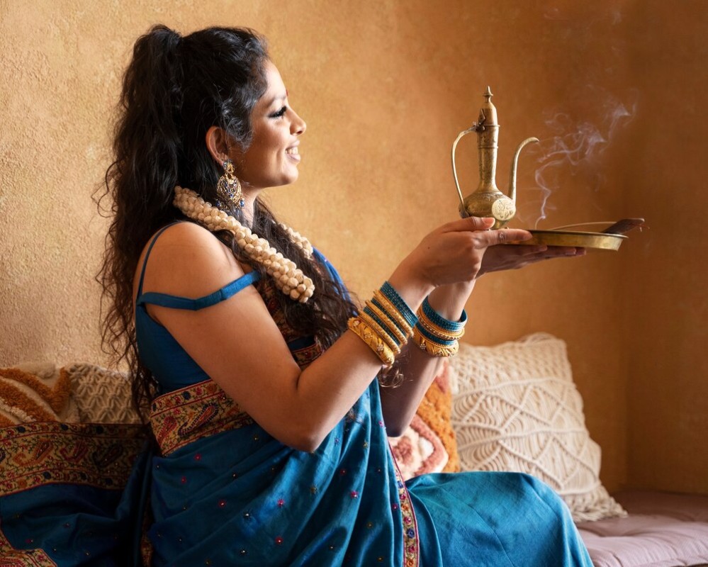 young-indian-woman-wearing-sari-holding-teapot_23-2149400912